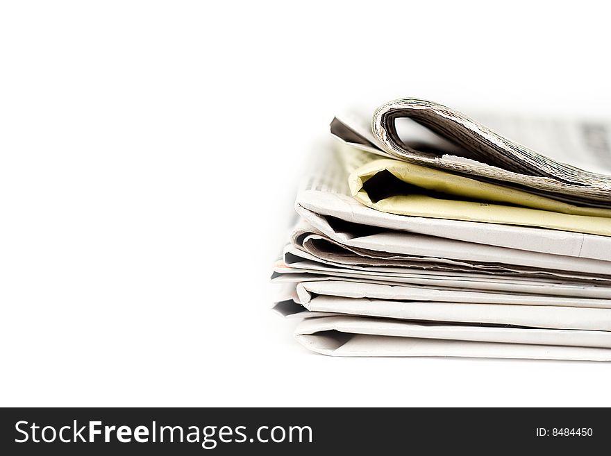 Stack of newspapers in color isolated on white background