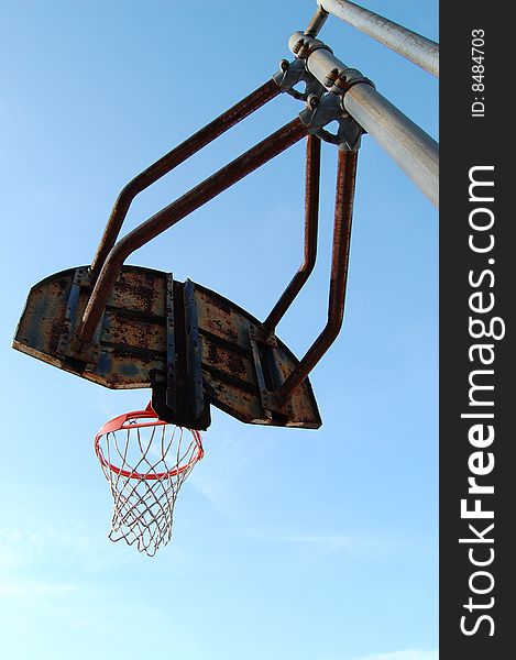 Photo taken from behind an old rusty basketball hoop. Photo taken from behind an old rusty basketball hoop.