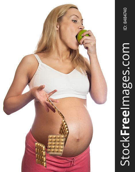 Pregnant woman with apple and tablets isolated on a white. Pregnant woman with apple and tablets isolated on a white