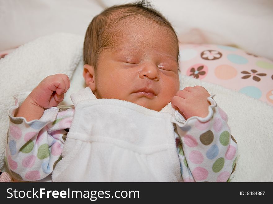 Newborn girl with dark hair sleeping peacefully. Newborn girl with dark hair sleeping peacefully