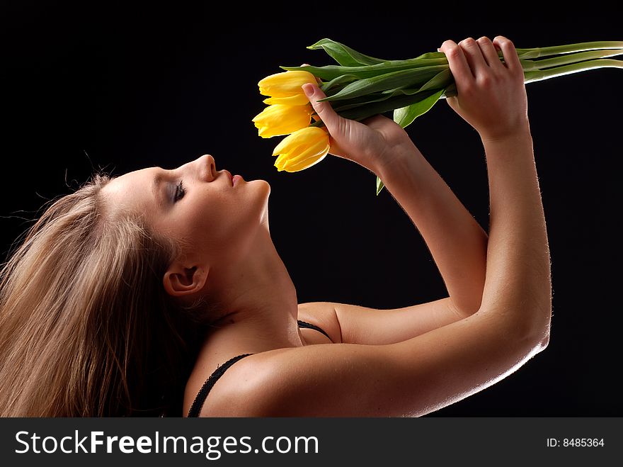 Beautiful woman in lingerie with bouquet of yellow tulips. Beautiful woman in lingerie with bouquet of yellow tulips