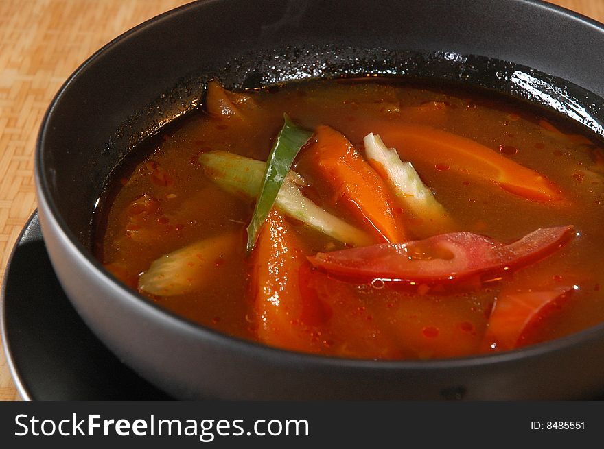 Vegetable soup in a black bowl