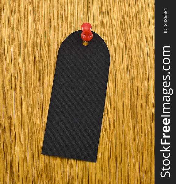 Black blank tag on wooden background