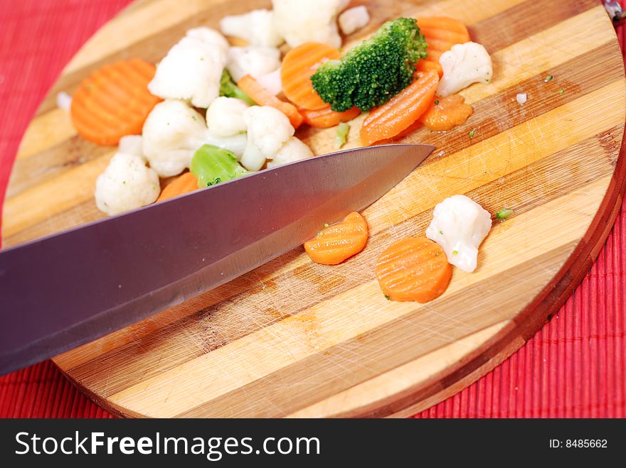 Wood board with knife and cut fresh vegetables. Wood board with knife and cut fresh vegetables