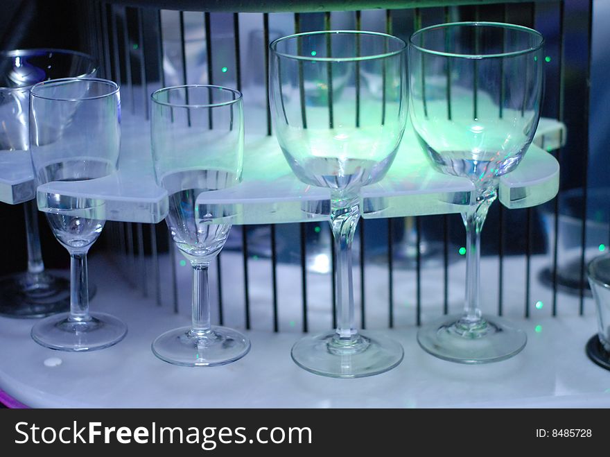 Illuminated bar counter with empty blue glass. Illuminated bar counter with empty blue glass