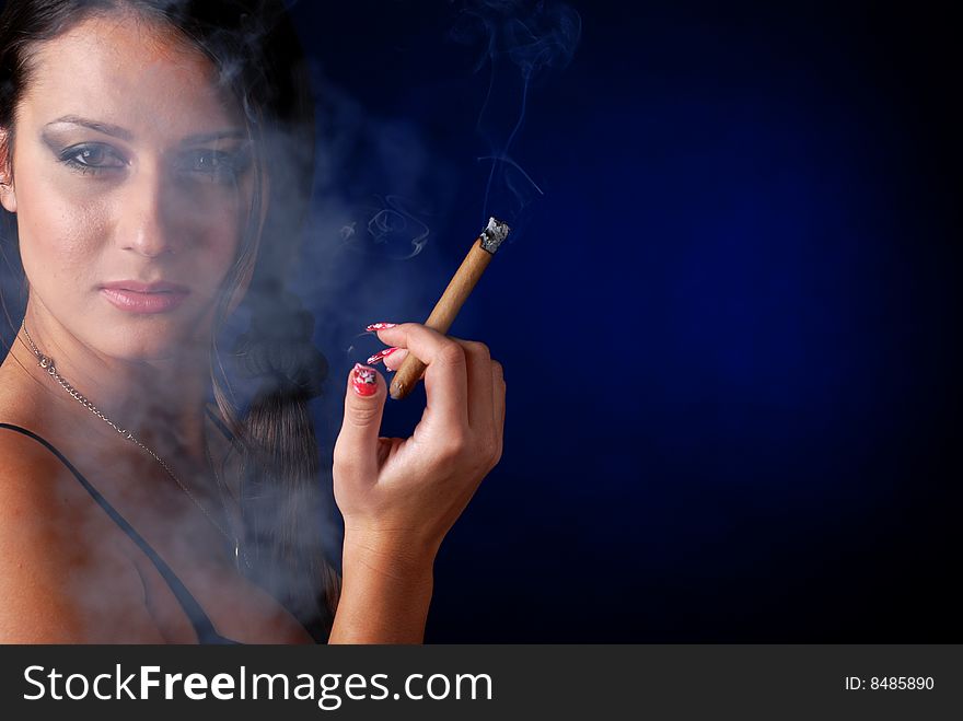 Portrait of beautiful brunet woman with cigar