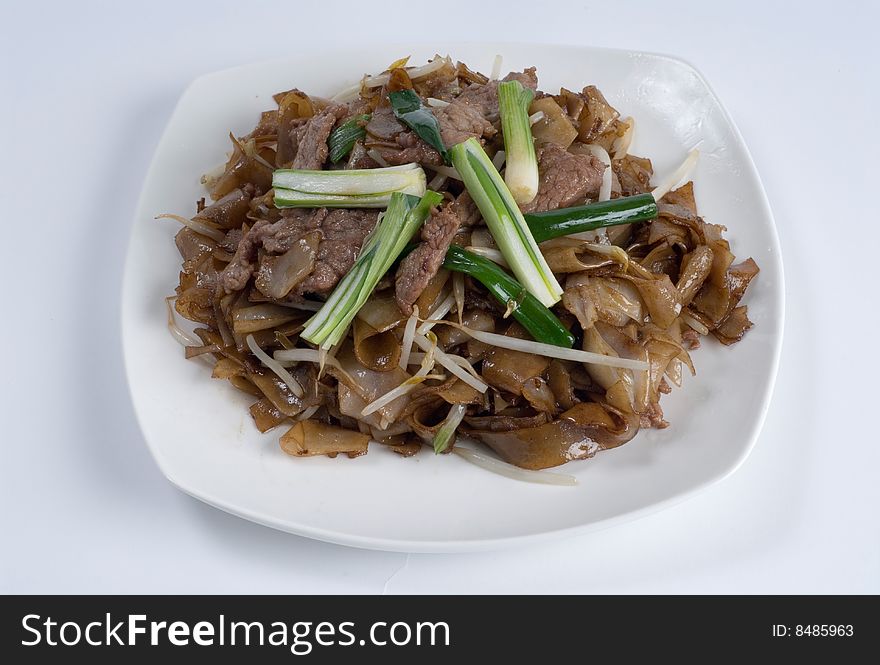 Seasoned beef over onions and egg noodles with chives