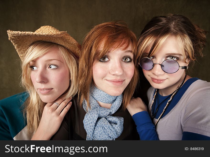 Portrait of three pretty young girls on a green background. Portrait of three pretty young girls on a green background