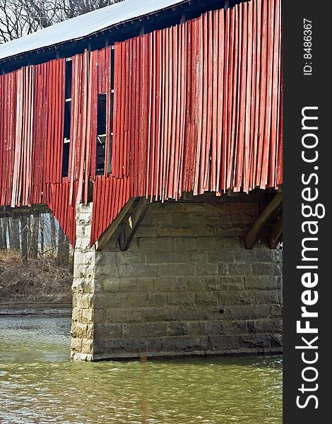 Old red wooden covered bridge with water underneath it in Indiana. Old red wooden covered bridge with water underneath it in Indiana