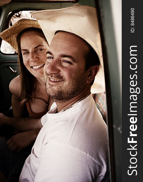 Portrait of Cowboy and woman in pickup truck cab