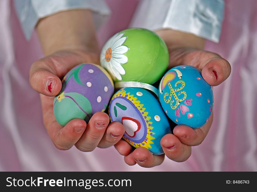 Little girl holding decorated Easter eggs. Little girl holding decorated Easter eggs.