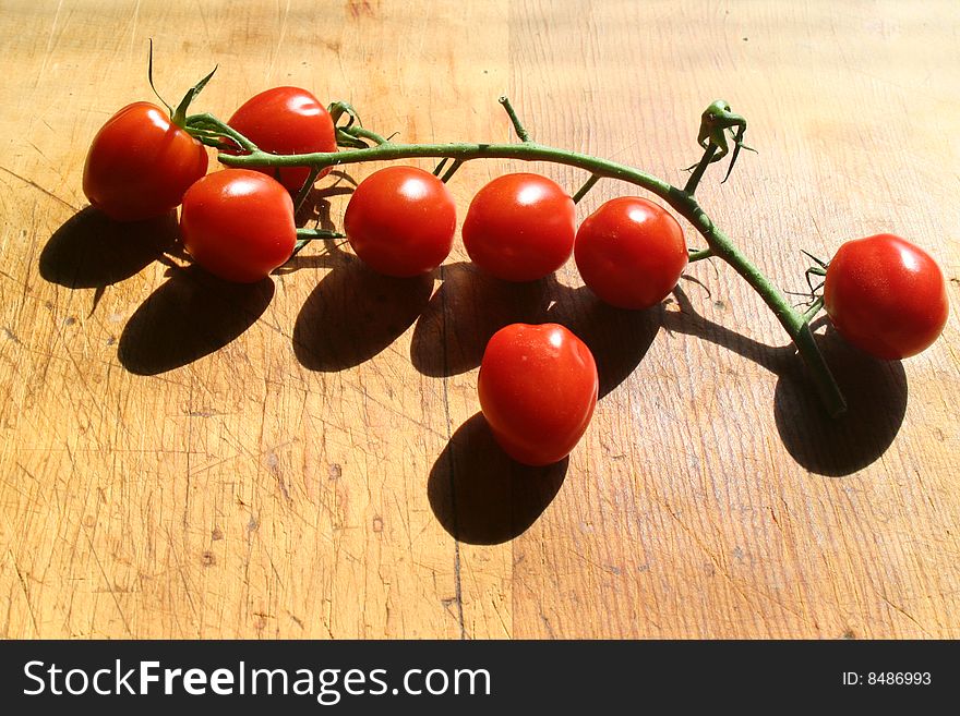 Vine ripened cherry tomatoes on a cutting board.
