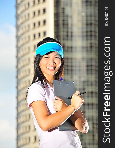 Asian Chinese Girl Holding Clipboard In City