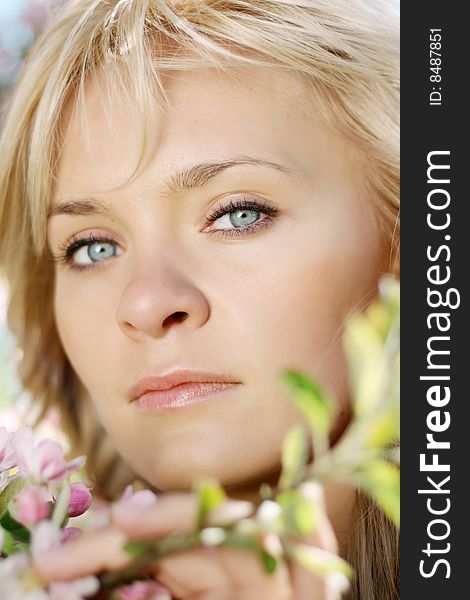 Picture of a beautiful girl in a flowering garden