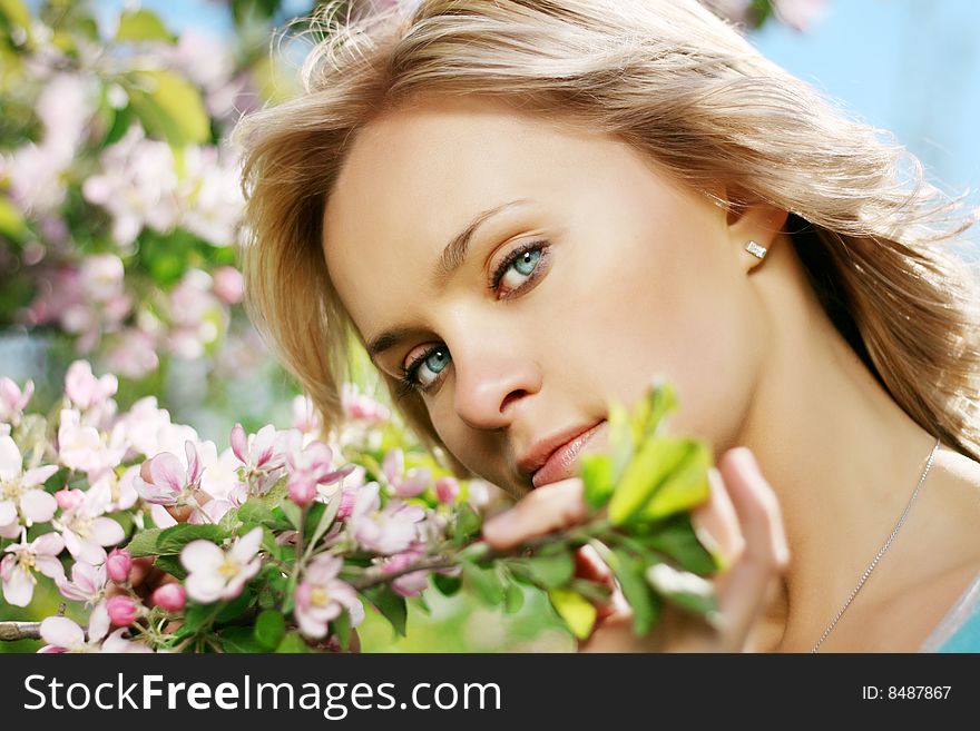 Picture of a beautiful girl in a flowering garden