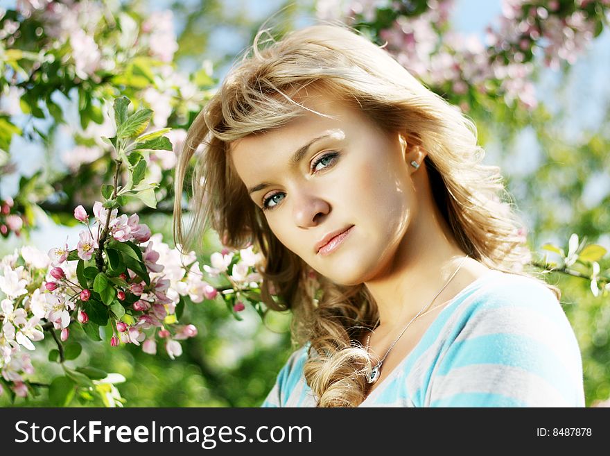 Picture of a beautiful girl in a flowering garden