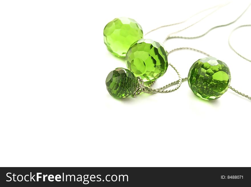 Necklace with transparent green beads on white background.