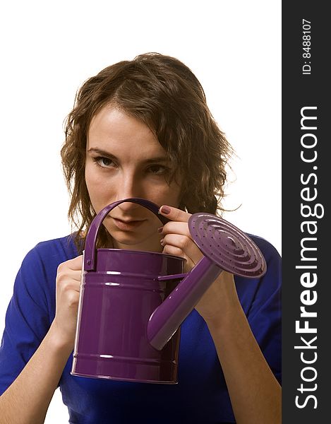 Girl keeps in hands purple watering can. Girl keeps in hands purple watering can