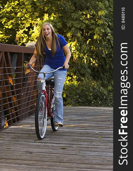 Pretty young female riding a bicycle. Pretty young female riding a bicycle.