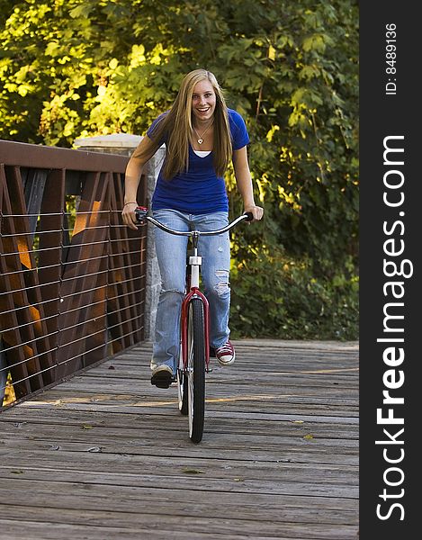 Pretty young female having fun riding a bicycle. Pretty young female having fun riding a bicycle.