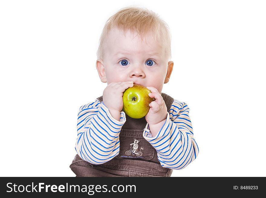 Little boy eating fresh apple on white background