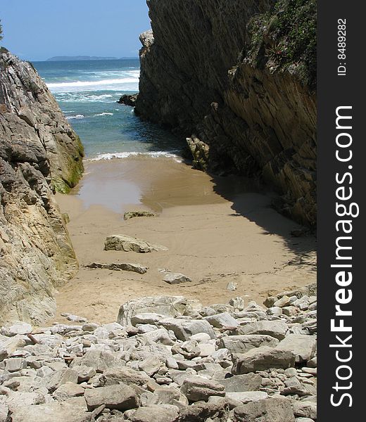 A private beach gully with rocks.