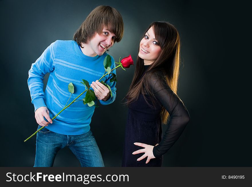 Romantic couple with rose, studio shot