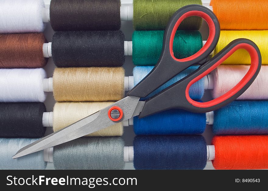 Closeup of multicolored sewing spools and scissors