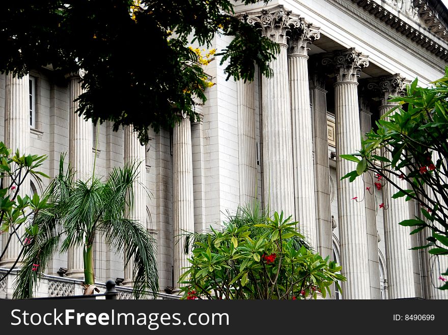 Massive Corinthian columns and capitols span the entire entrance facade of 1926 Old City Hall in Singapore's historic colonial district - Lee Snider Photo. Massive Corinthian columns and capitols span the entire entrance facade of 1926 Old City Hall in Singapore's historic colonial district - Lee Snider Photo.