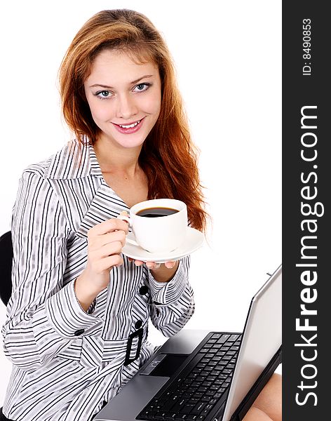 Young business woman with a laptop and drinking coffee. Young business woman with a laptop and drinking coffee