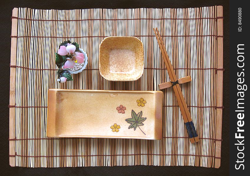 View from above of sushi plate and chopsticks on mat. View from above of sushi plate and chopsticks on mat