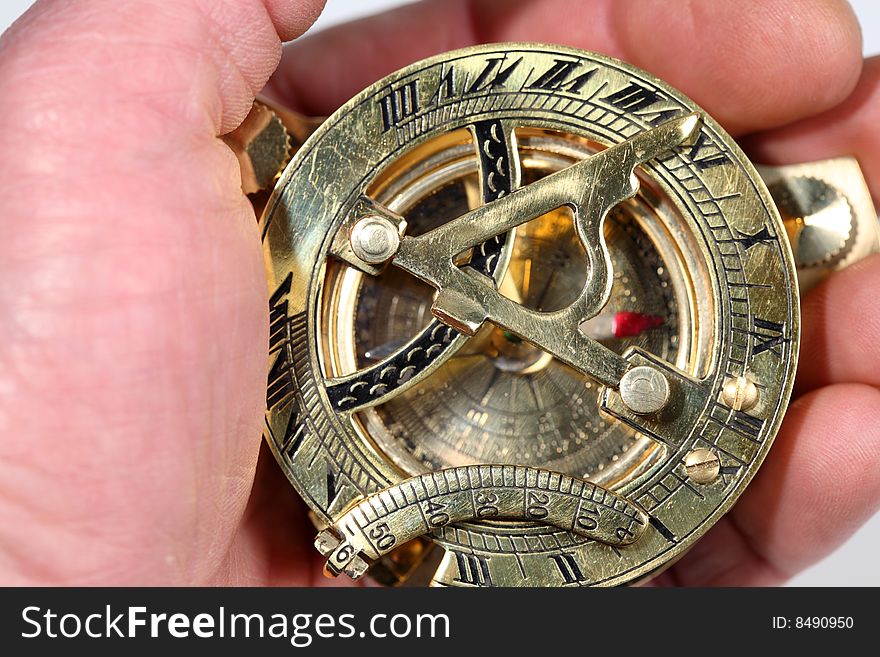 Hand with antique, bronze compass. Hand with antique, bronze compass.