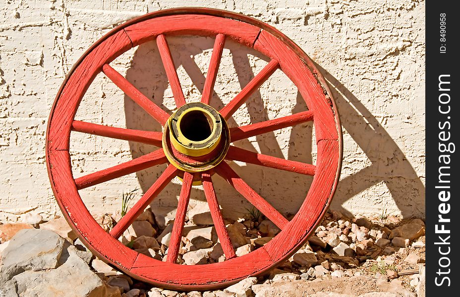 A brightly colored vintage wagon wheel. A brightly colored vintage wagon wheel