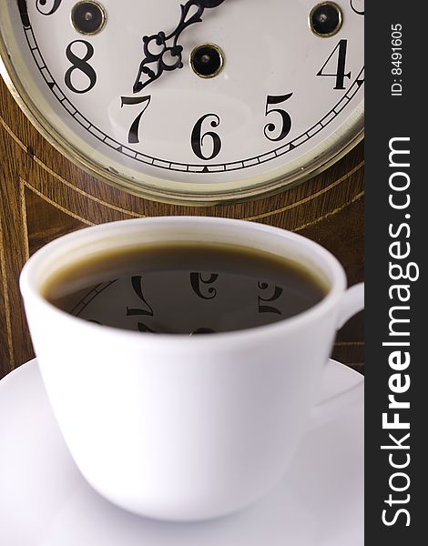 Close up of a clock and cup of coffe. Close up of a clock and cup of coffe