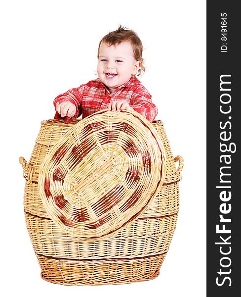 Baby boy sitting in basket. Isolated