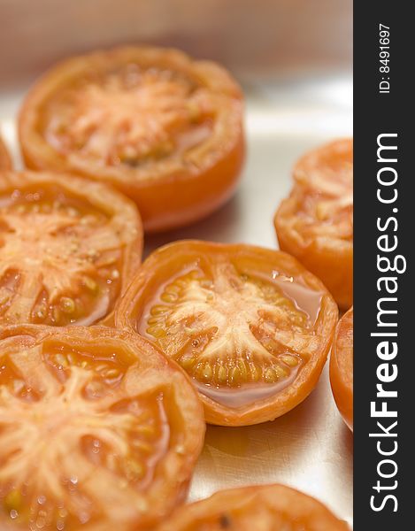 Grilled tomatoes in oven tray. Selective focus, vertical composition. Grilled tomatoes in oven tray. Selective focus, vertical composition.