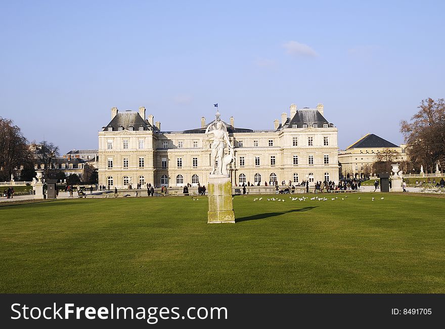 Classical building with meadow, blue sky and ancient building