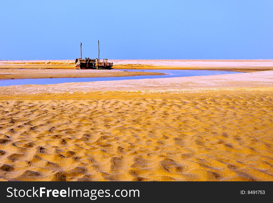 Fishing boat and sand beach