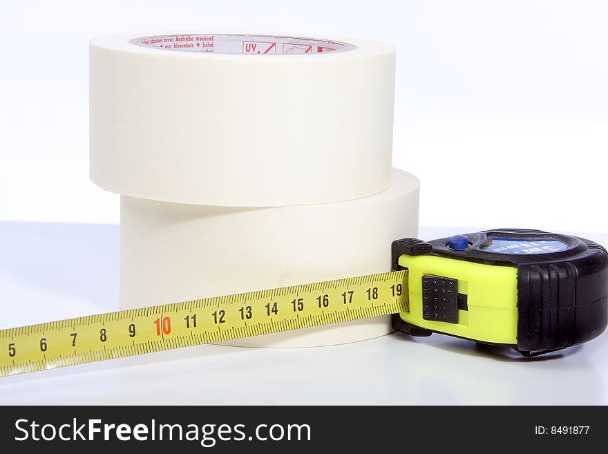 Photograph of rolls of tape and a Tape measure. Photograph of rolls of tape and a Tape measure