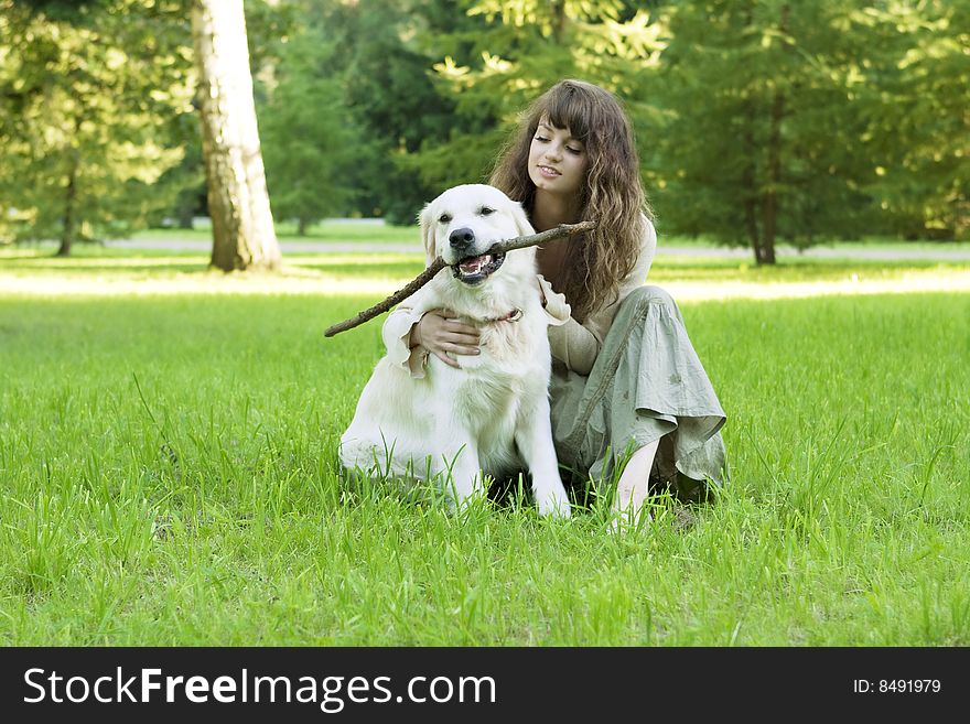 Girl With The Golden Retriever In The Park