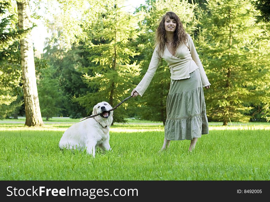 Picture of the girl with the golden retriever walk in the park. Picture of the girl with the golden retriever walk in the park