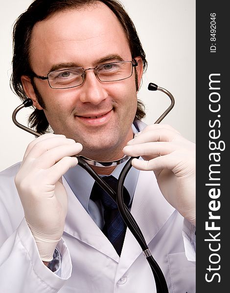 Smiling doctor with stethoscope over white. Smiling doctor with stethoscope over white