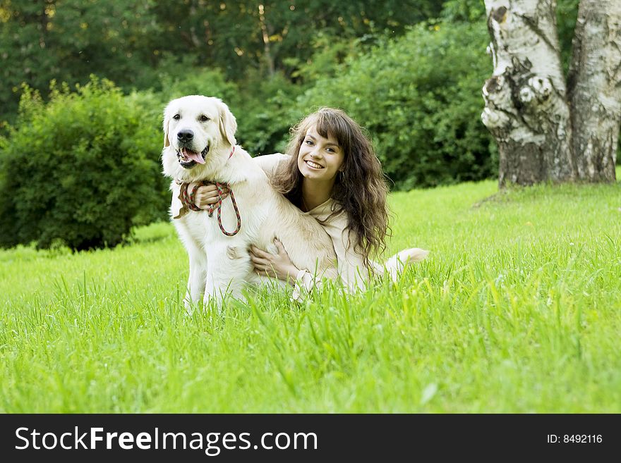 Girl With The Golden Retriever In The Park