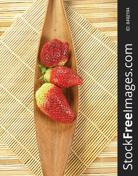 Strawberries on cocco leaf and bamboo mats. Strawberries on cocco leaf and bamboo mats