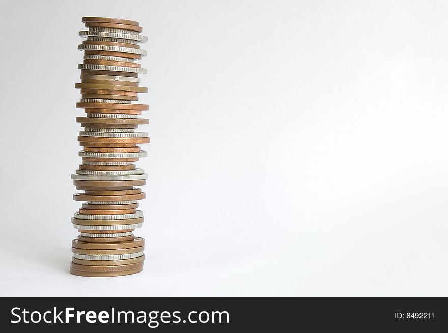 Stack of British copper and silver coins. Copy space included, plain background. Sharp image taken in a studio. Stack of British copper and silver coins. Copy space included, plain background. Sharp image taken in a studio.