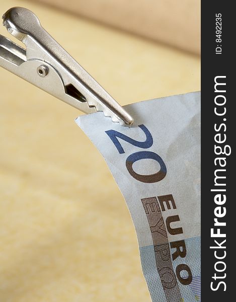 Blue twenty euro banknote with tweezers