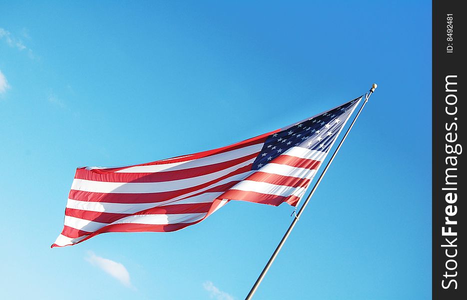 American flag with blue sky as the background