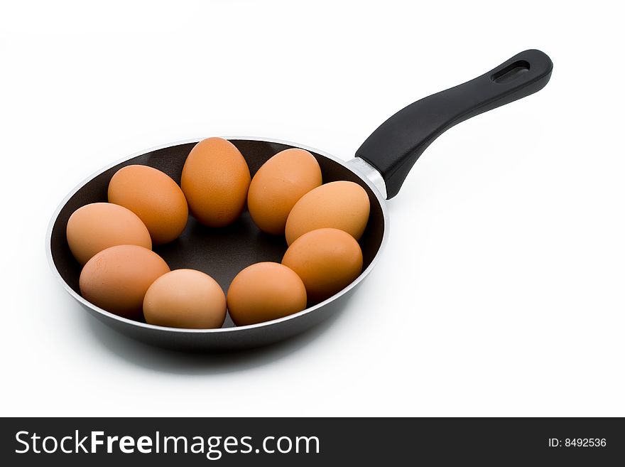 Whole raw eggs in a pan isolated on white