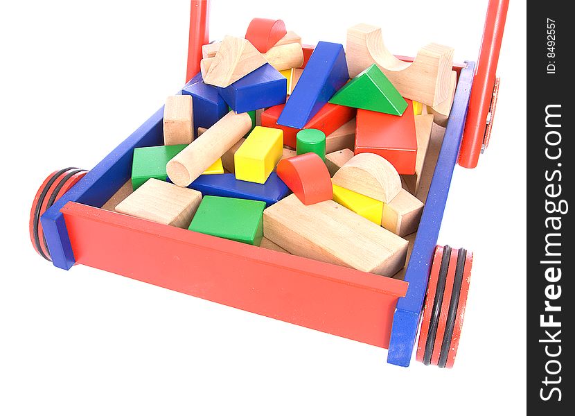 Toy building blocks in a cart isolated on a white background