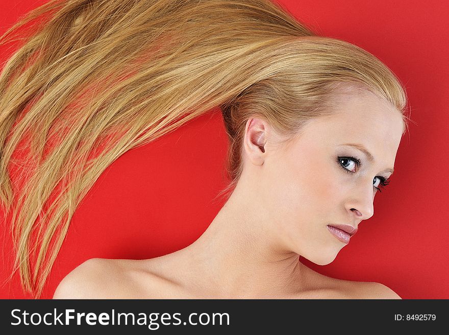 Beautiful blond woman and red background. Beautiful blond woman and red background